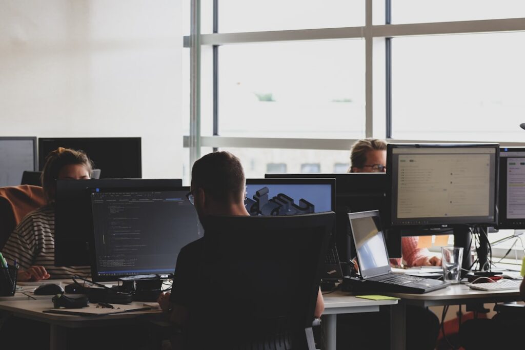 Engineers working at multiple monitors in an open office