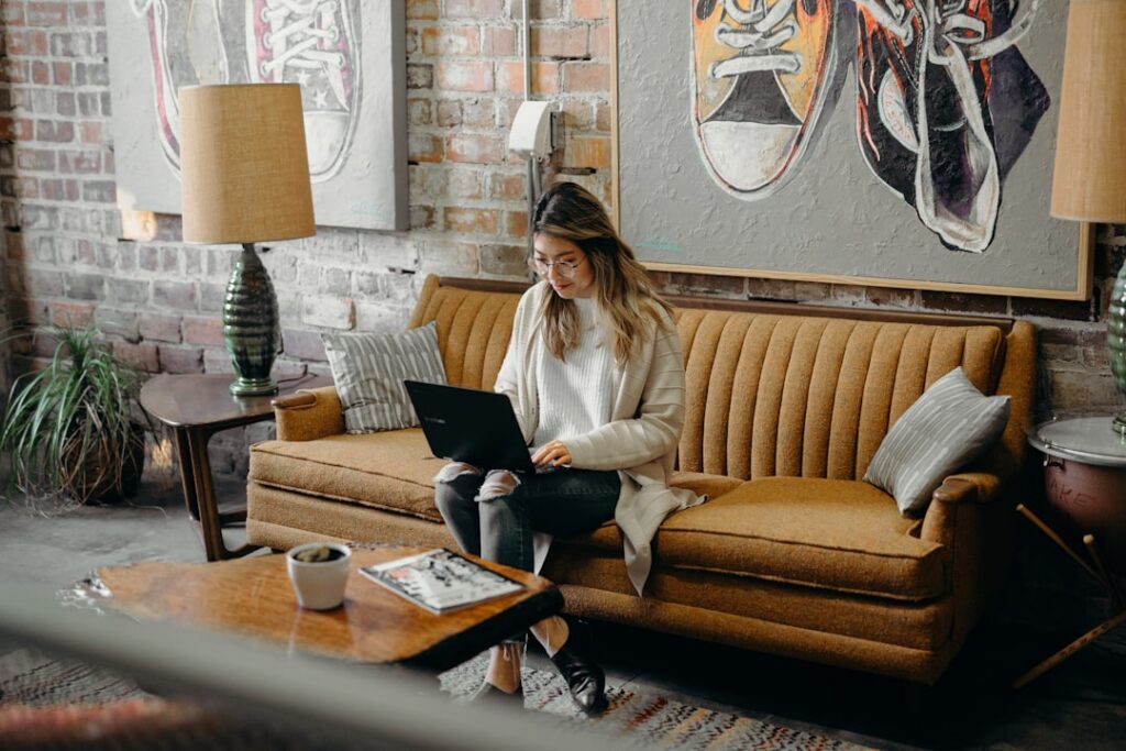 Professional working on a laptop in a relaxed lounge setting